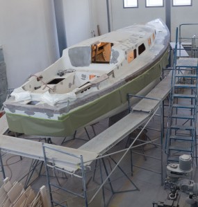 Rails have been glassed half way back from the bow. The green paper is a drip skirt to catch most of our drips.