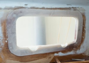 The inside view of the forward porthole opening. The shim gives a flat surface for the port to mount to.