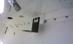 Inside the starboard locker.  Just a few bolts.